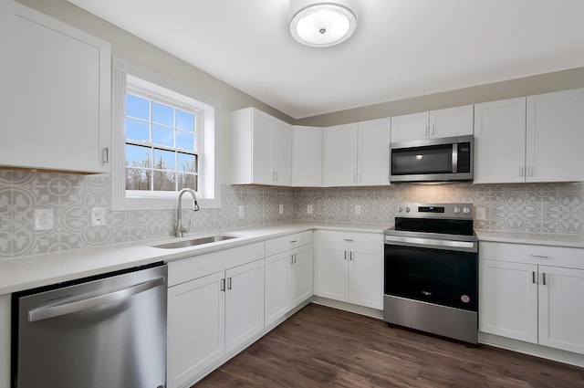 kitchen with sink, white cabinets, and appliances with stainless steel finishes