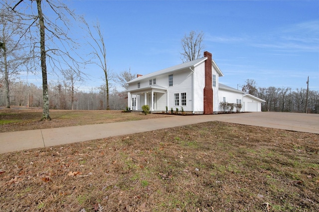 view of front of home with a porch, a garage, and a front lawn