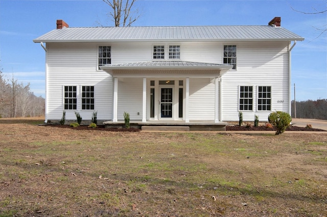 view of front facade featuring a front lawn and covered porch