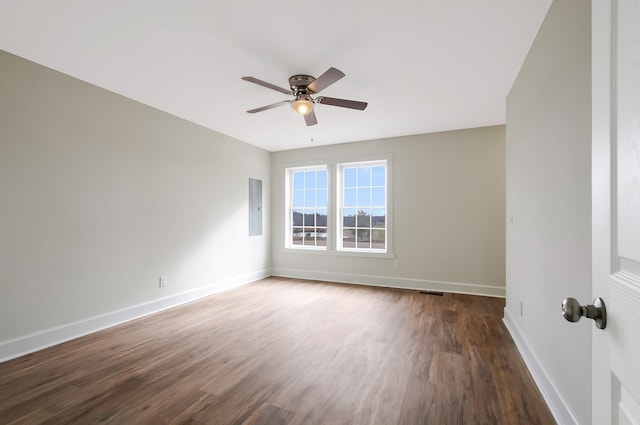 empty room featuring wood-type flooring, electric panel, and ceiling fan