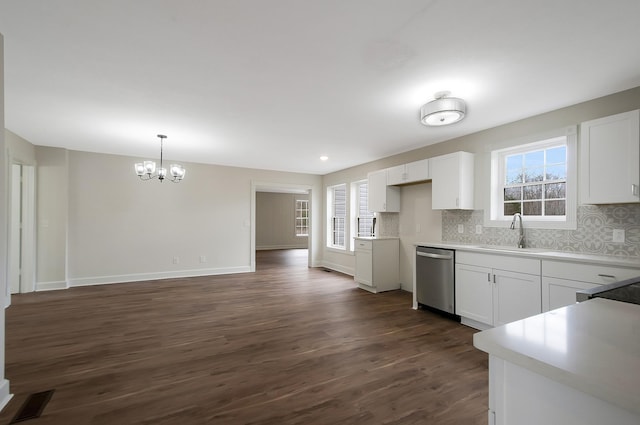 kitchen with white cabinetry, stainless steel dishwasher, and sink