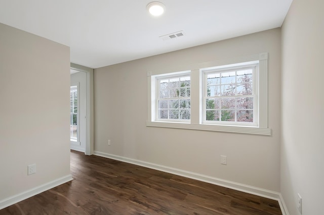 unfurnished room featuring dark hardwood / wood-style flooring