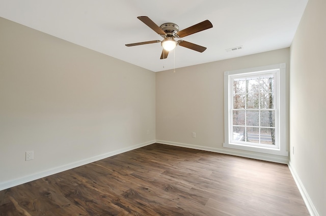 unfurnished room with ceiling fan and dark hardwood / wood-style floors