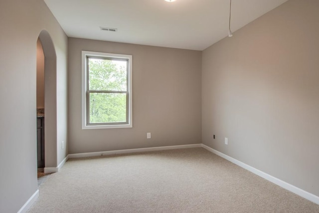 unfurnished room with light colored carpet