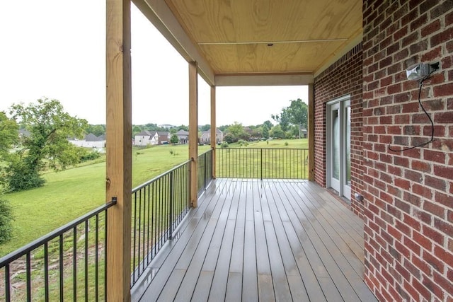 wooden terrace featuring a lawn