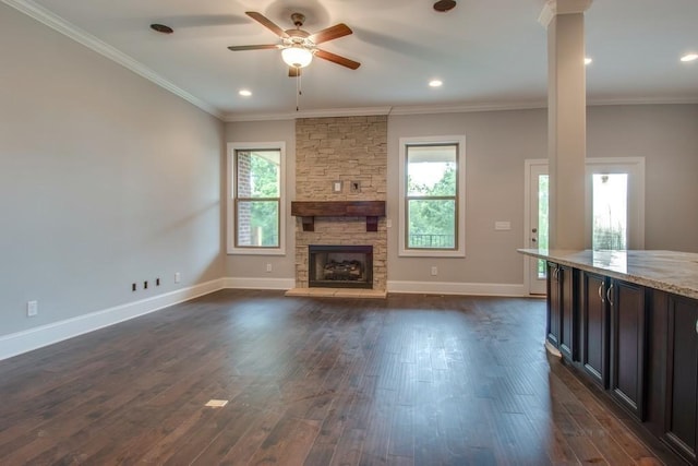 unfurnished living room with a wealth of natural light, ornamental molding, and dark hardwood / wood-style floors