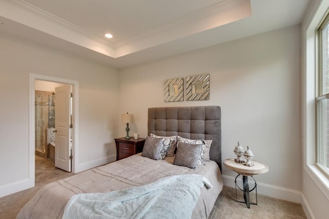 bedroom featuring ornamental molding, light carpet, and a tray ceiling