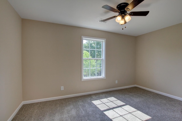 carpeted spare room with ceiling fan