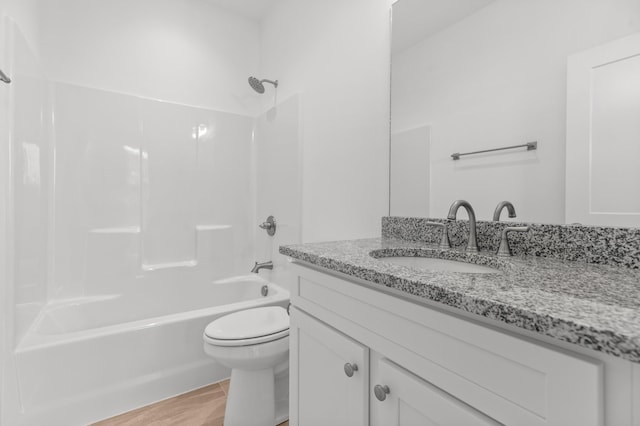 full bathroom featuring vanity, bathtub / shower combination, and toilet