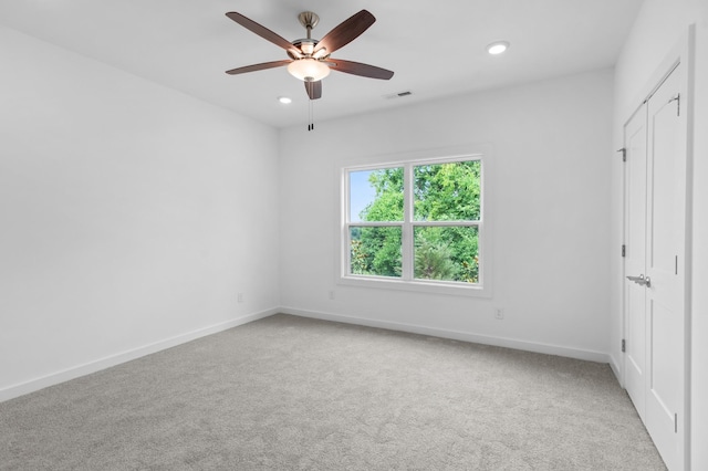 unfurnished bedroom featuring carpet flooring, ceiling fan, and a closet