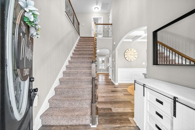 entryway featuring a high ceiling and dark hardwood / wood-style floors