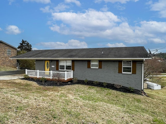 ranch-style house with a porch and a front lawn