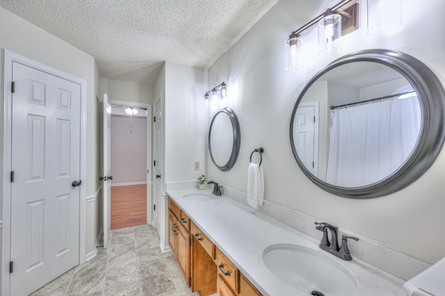 bathroom with vanity and a textured ceiling