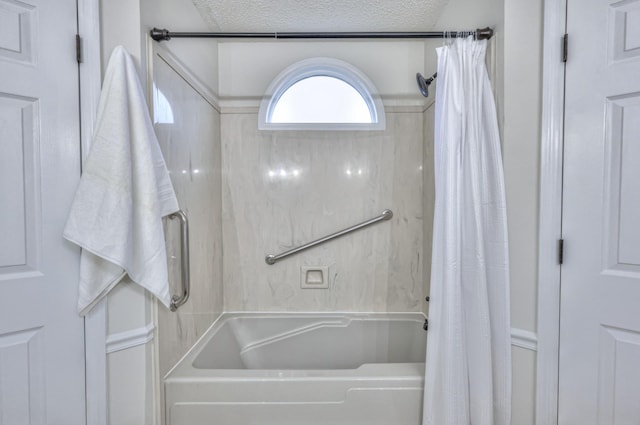 bathroom featuring a textured ceiling and shower / bath combo with shower curtain