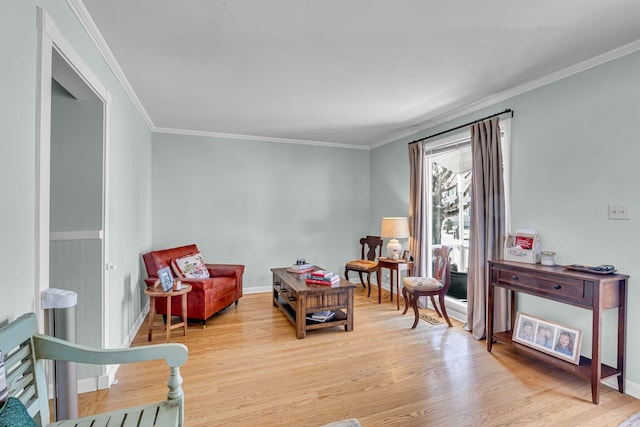 living area featuring ornamental molding and light wood-type flooring