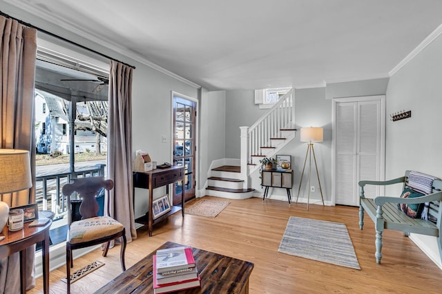 sitting room with hardwood / wood-style flooring and ornamental molding