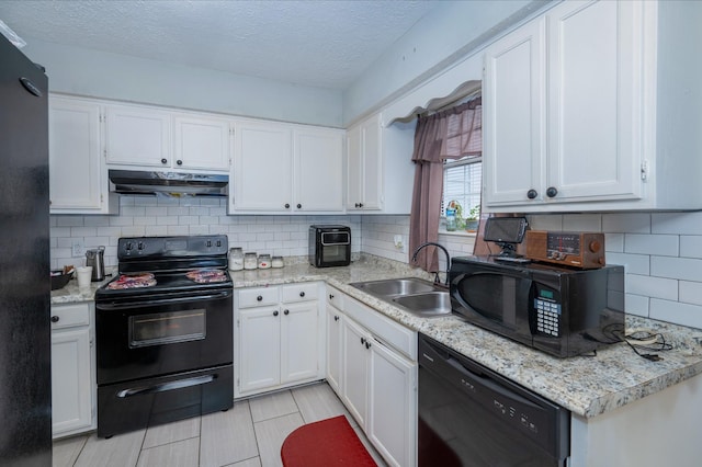 kitchen featuring sink, white cabinets, backsplash, and black appliances