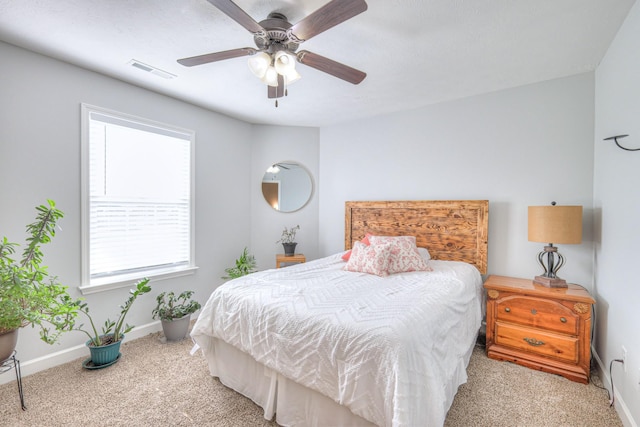 bedroom featuring light colored carpet and ceiling fan