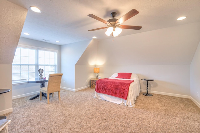 carpeted bedroom with ceiling fan and a textured ceiling