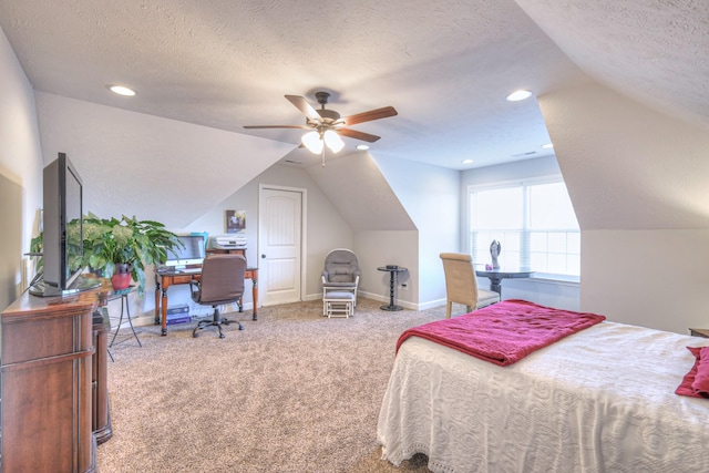 bedroom featuring vaulted ceiling, carpet, and a textured ceiling