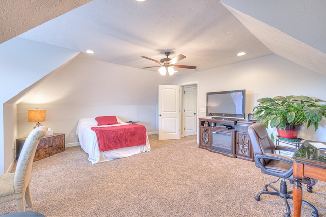 bedroom with carpet floors, vaulted ceiling, a textured ceiling, and ceiling fan