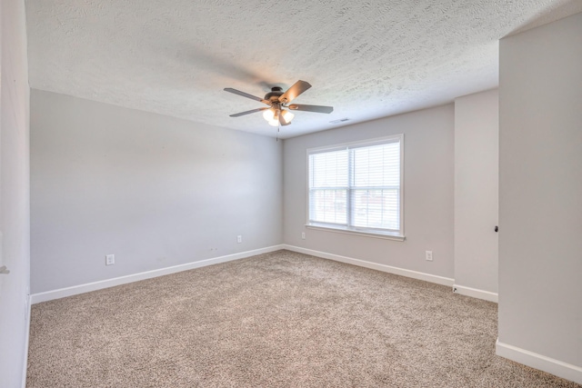 unfurnished room featuring a textured ceiling, visible vents, carpet, baseboards, and a ceiling fan