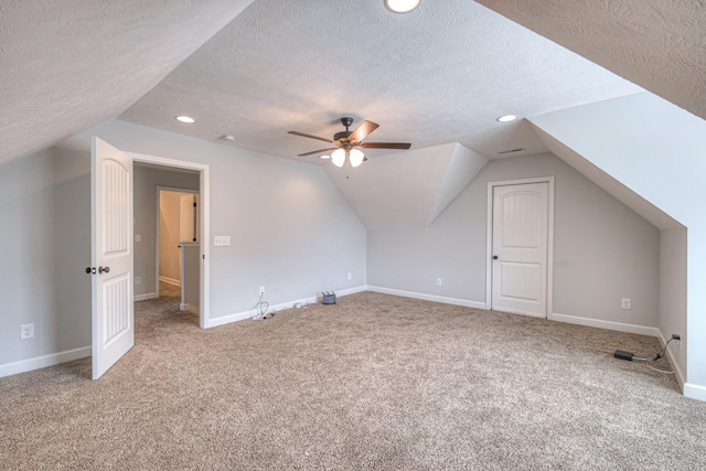bonus room with carpet, baseboards, lofted ceiling, and a textured ceiling