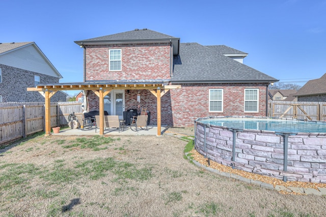 back of house featuring a patio, a fenced backyard, a fenced in pool, brick siding, and a pergola