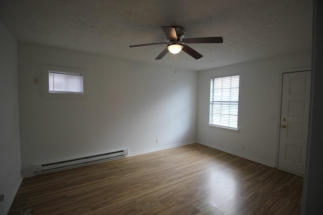 unfurnished room with a baseboard heating unit, wood-type flooring, a textured ceiling, and ceiling fan