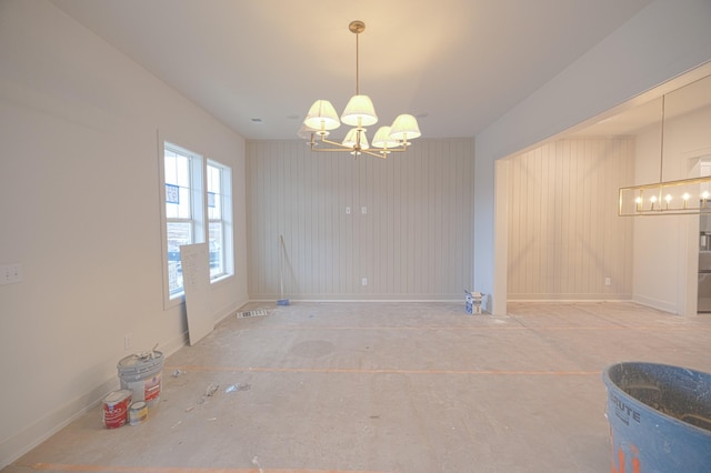 unfurnished dining area featuring an inviting chandelier