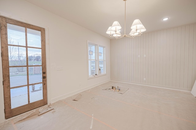 unfurnished dining area featuring a chandelier, recessed lighting, baseboards, and a healthy amount of sunlight