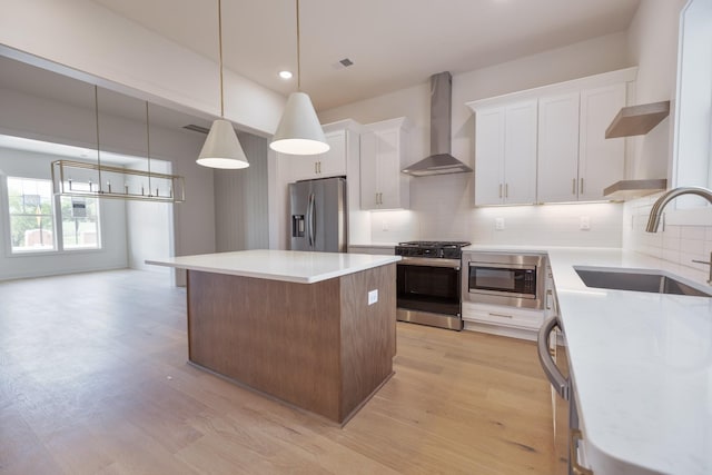 4044 Penfield Dr Unit C, Franklin, TN 37069 - kitchen featuring a sink, stainless steel appliances, wall chimney range hood, decorative backsplash, and a center island