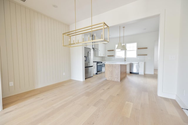 4044 Penfield Dr Unit C, Franklin, TN 37069 - kitchen featuring light wood-style flooring, open shelves, a kitchen island, light countertops, and appliances with stainless steel finishes