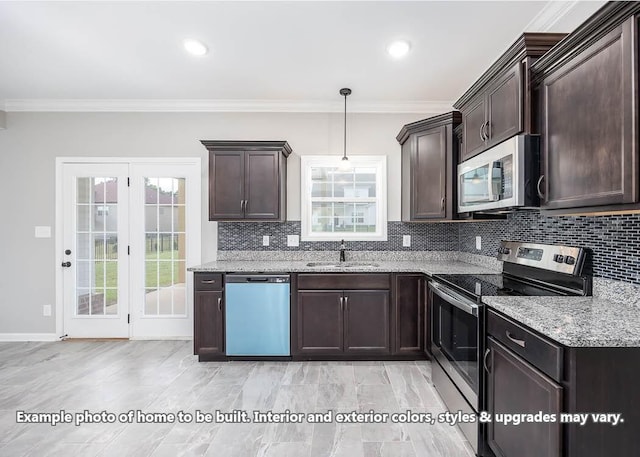 kitchen with sink, crown molding, light stone counters, pendant lighting, and stainless steel appliances