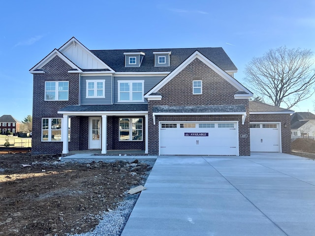 view of front of home with driveway, a shingled roof, board and batten siding, and brick siding