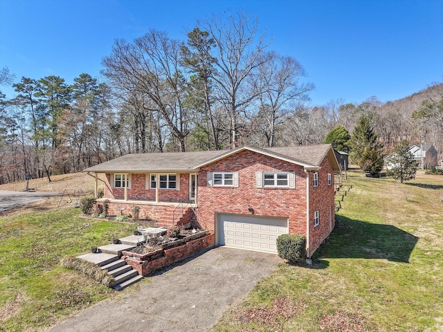 view of front facade featuring driveway, a garage, stairway, a front lawn, and brick siding