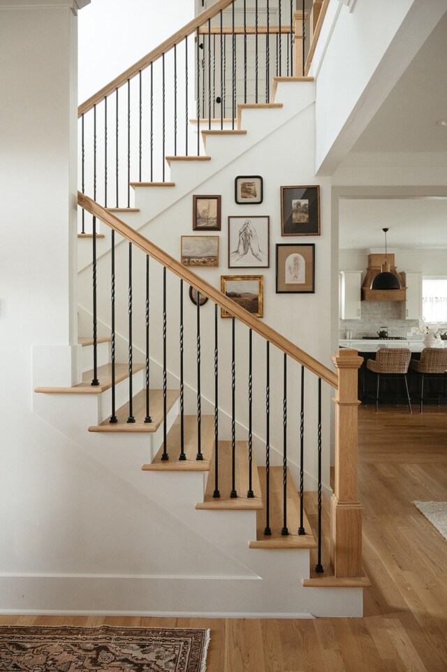 staircase with hardwood / wood-style flooring