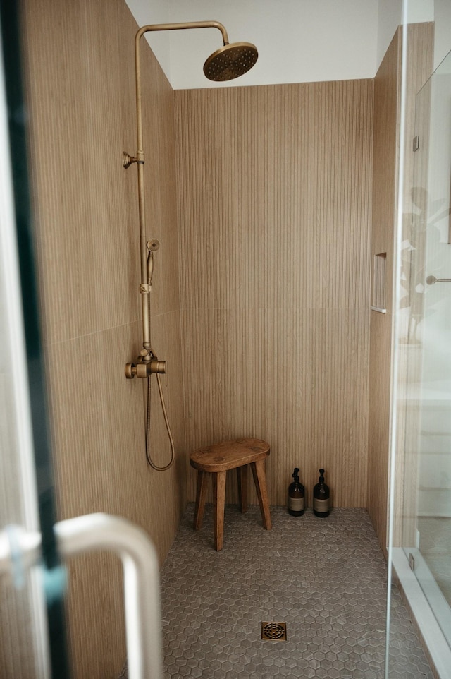 bathroom with a shower with door