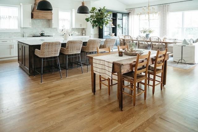 dining area featuring an inviting chandelier and light wood-type flooring