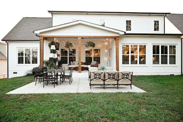 back of property with a yard, an outdoor hangout area, and a patio