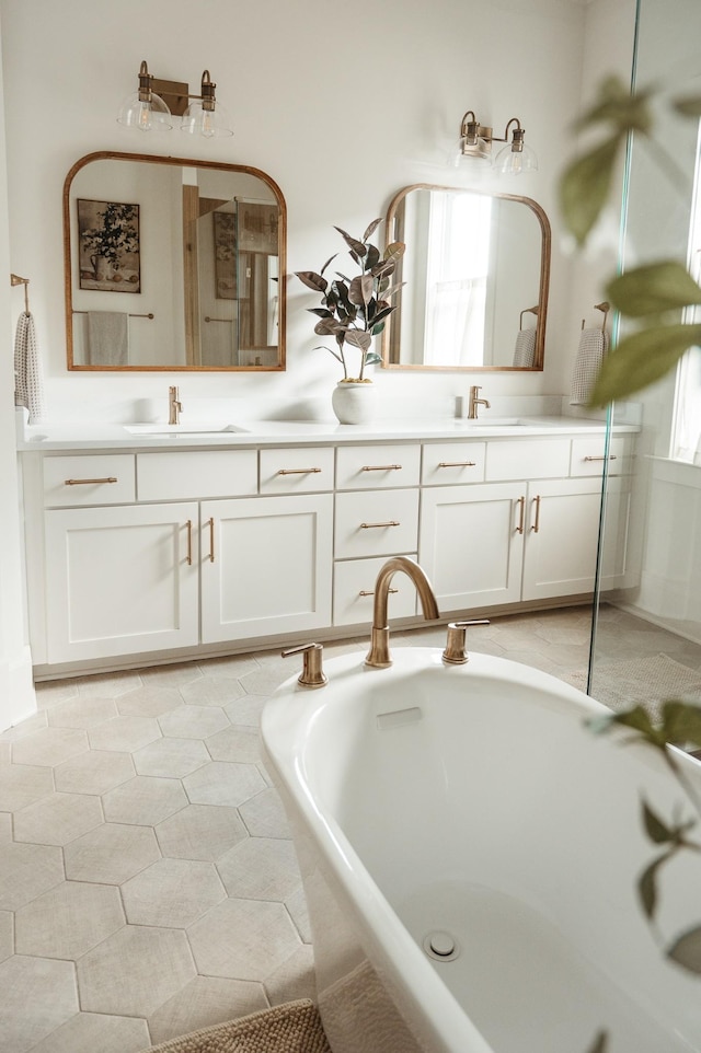 bathroom featuring vanity and tiled tub