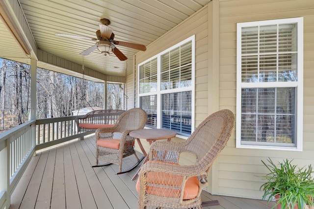 deck with ceiling fan and a porch