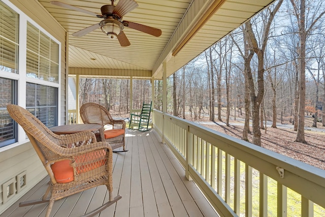 wooden deck featuring ceiling fan