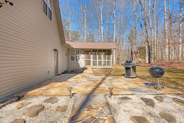 view of patio / terrace featuring a grill and a sunroom