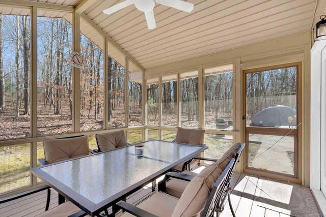 sunroom / solarium featuring ceiling fan, a wealth of natural light, and lofted ceiling