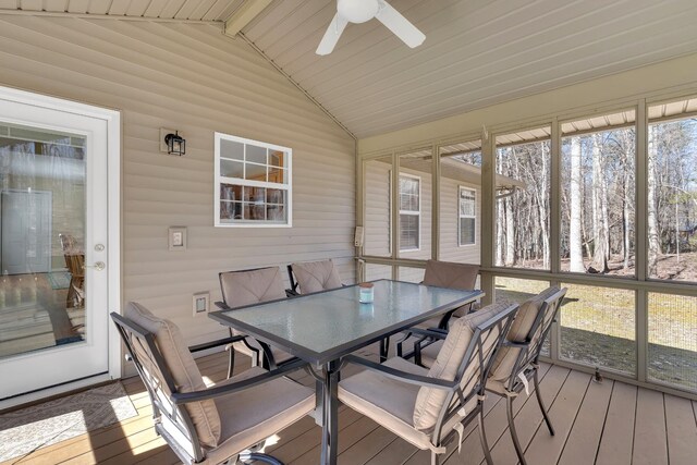 sunroom with ceiling fan and lofted ceiling with beams