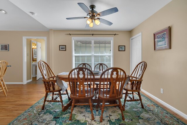 dining space featuring light wood-type flooring and ceiling fan