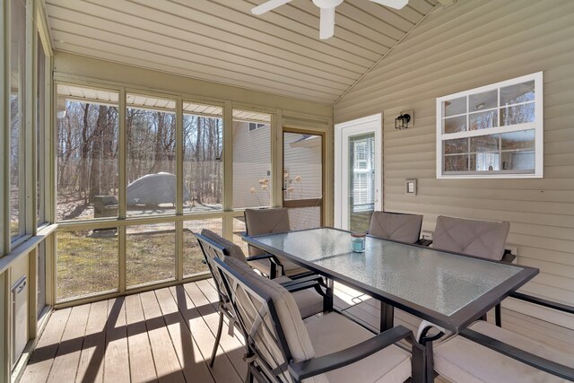 sunroom / solarium with ceiling fan, vaulted ceiling, and a healthy amount of sunlight