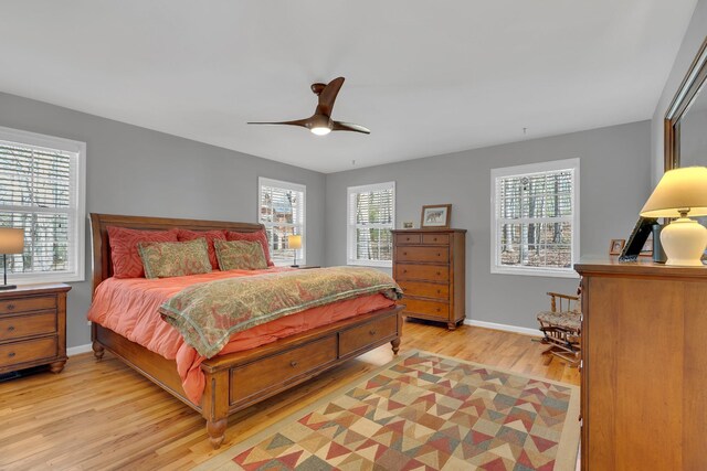 bedroom with light hardwood / wood-style floors and ceiling fan