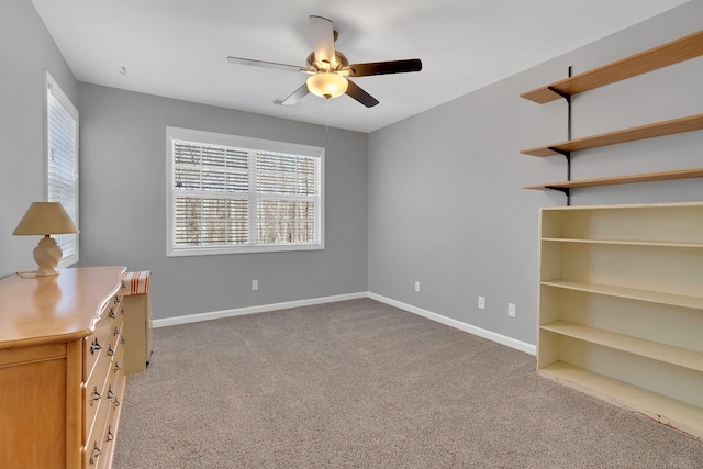 unfurnished bedroom featuring multiple windows, ceiling fan, and light colored carpet